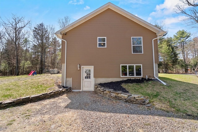 back of property featuring a yard