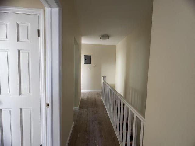 hallway featuring electric panel, baseboards, an upstairs landing, and wood finished floors