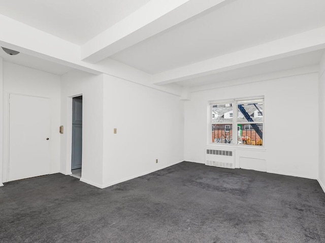 unfurnished room with beamed ceiling, radiator heating unit, and dark colored carpet