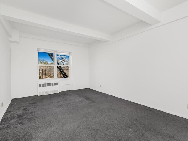 spare room with beamed ceiling, radiator heating unit, and dark colored carpet