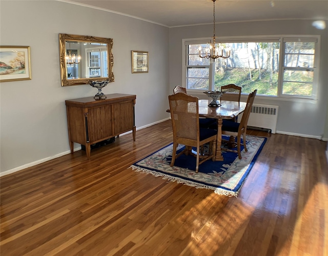 dining room with radiator, baseboards, a chandelier, ornamental molding, and wood finished floors