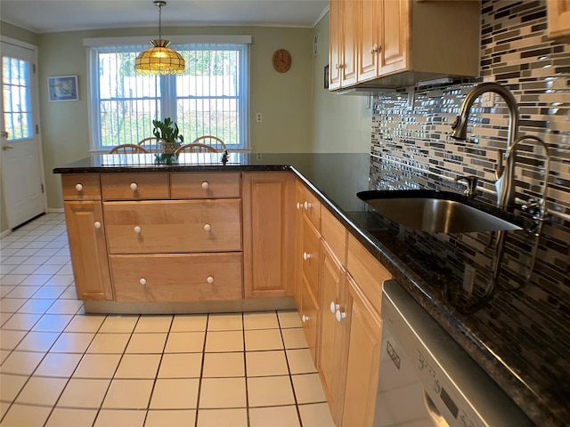 kitchen featuring light tile patterned floors, a peninsula, white dishwasher, a sink, and tasteful backsplash