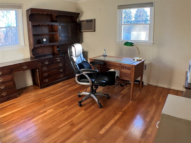 office space featuring an AC wall unit and light wood finished floors