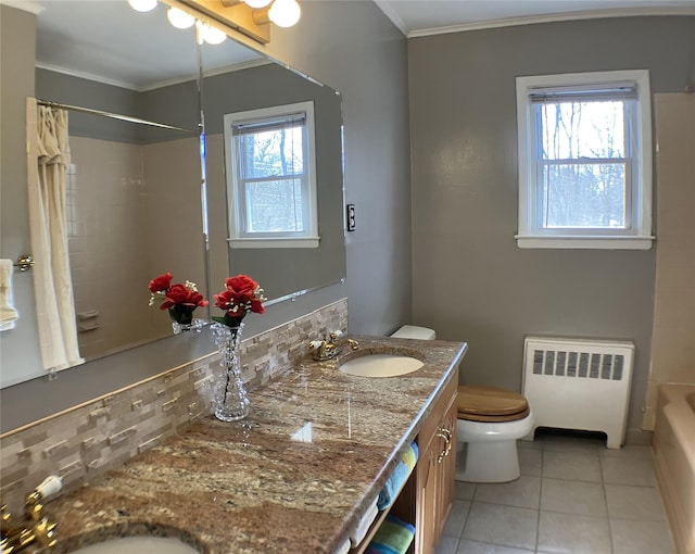 full bathroom featuring toilet, crown molding, radiator heating unit, and a sink