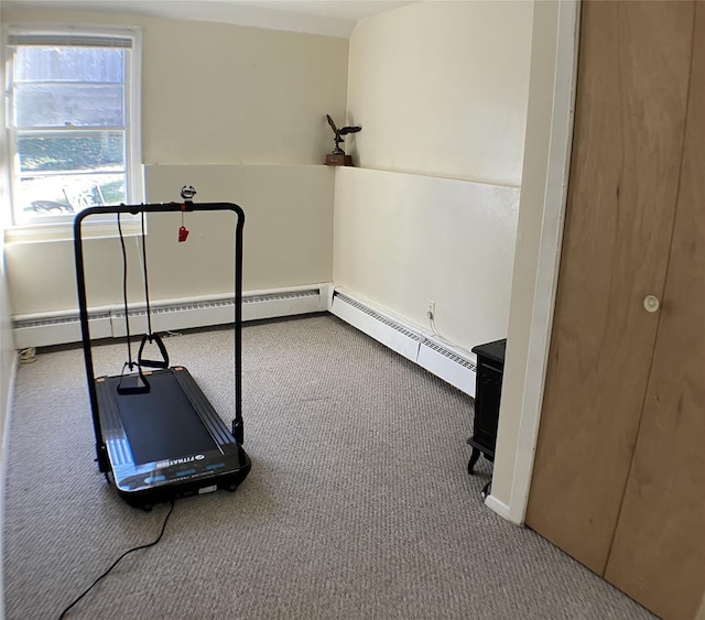 exercise area with carpet floors and baseboard heating