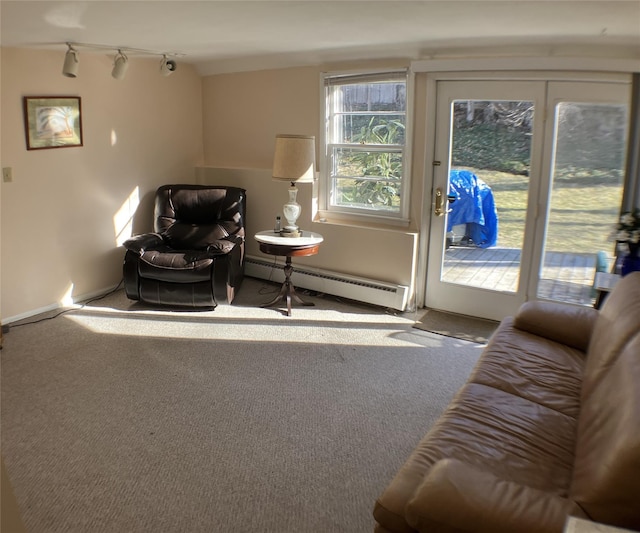 living area featuring track lighting, carpet flooring, and baseboard heating