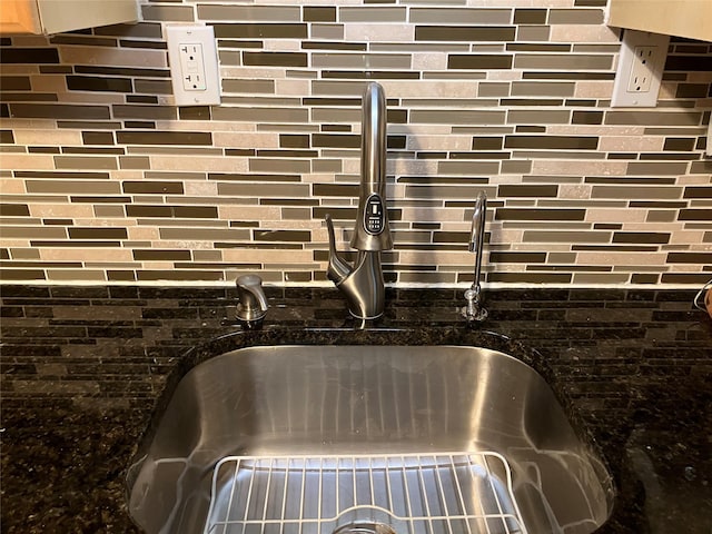 interior details with dark stone counters and a sink