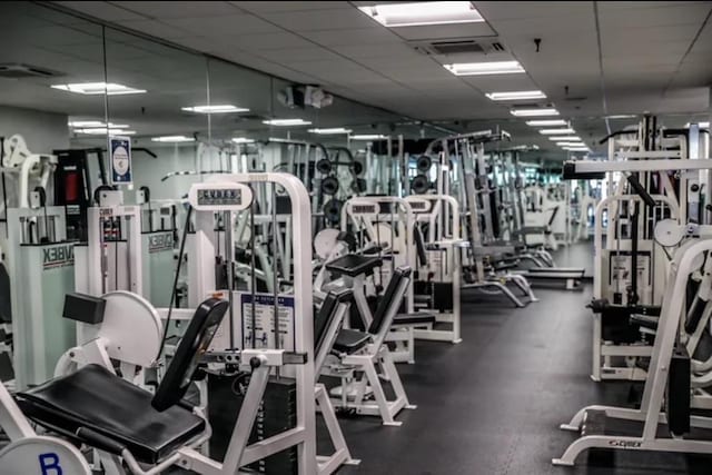 gym with visible vents and a drop ceiling