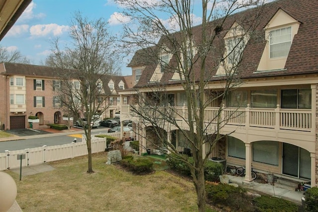 surrounding community with a yard and fence