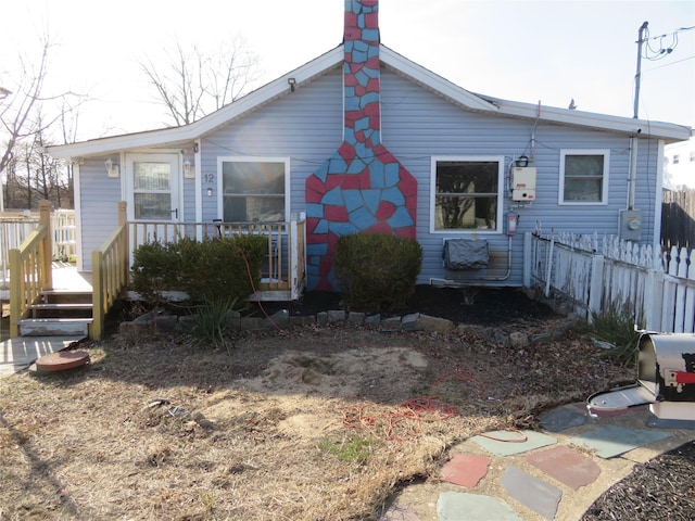 exterior space with fence and water heater