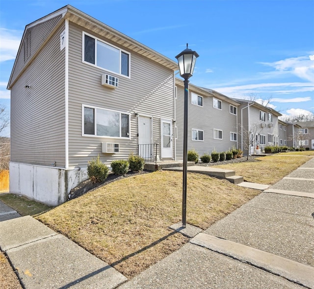 townhome / multi-family property with a front yard and a residential view