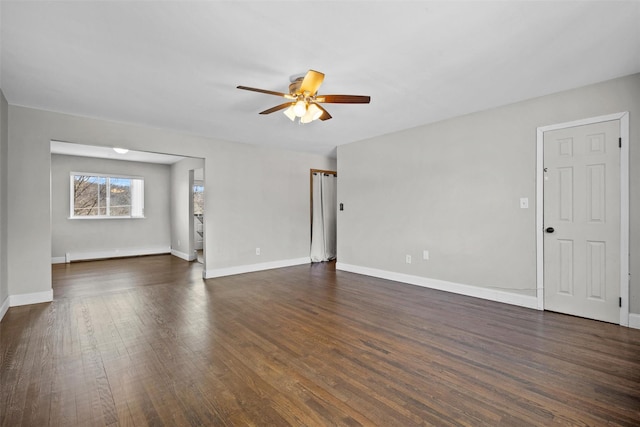 unfurnished living room with baseboards, dark wood-type flooring, and ceiling fan