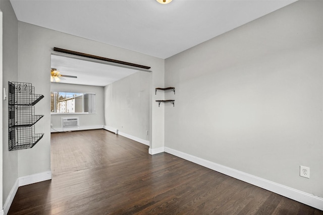 unfurnished living room with baseboards, dark wood finished floors, a ceiling fan, and a wall unit AC