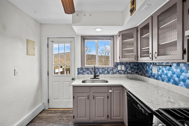 kitchen with a sink, gray cabinetry, glass insert cabinets, dishwasher, and baseboard heating