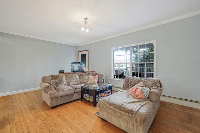 living area with light wood finished floors, baseboard heating, crown molding, and baseboards