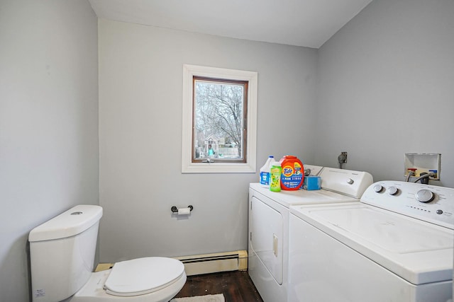 laundry area with a baseboard heating unit, dark wood finished floors, laundry area, and washing machine and clothes dryer