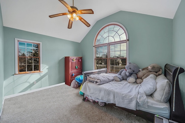 carpeted bedroom with lofted ceiling, baseboards, and ceiling fan