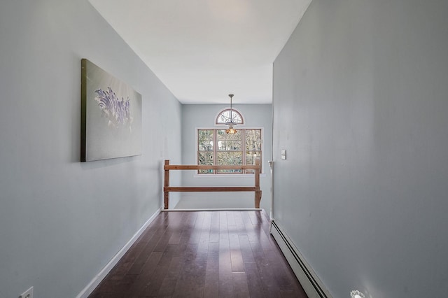 corridor with baseboards and wood finished floors