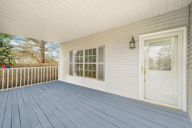 wooden terrace featuring fence