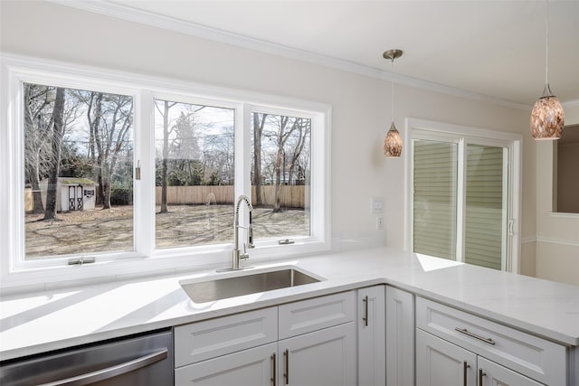 kitchen featuring ornamental molding, a sink, white cabinetry, dishwasher, and hanging light fixtures