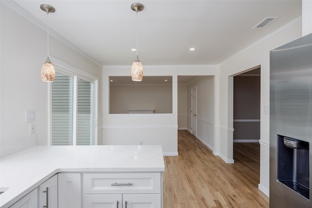 kitchen with white cabinetry, crown molding, visible vents, and light wood-type flooring