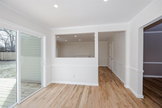 spare room with crown molding, recessed lighting, wood finished floors, and baseboards