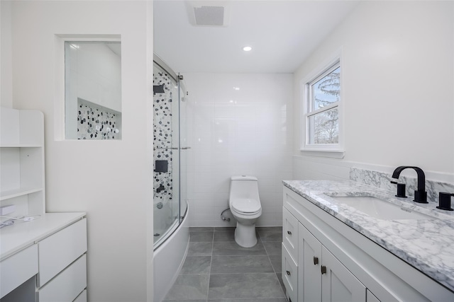 full bathroom with tile patterned floors, toilet, combined bath / shower with glass door, recessed lighting, and vanity