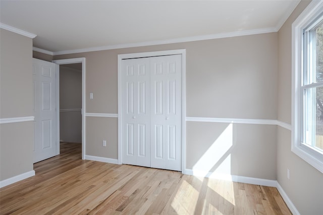 unfurnished bedroom with wood finished floors, a closet, and baseboards