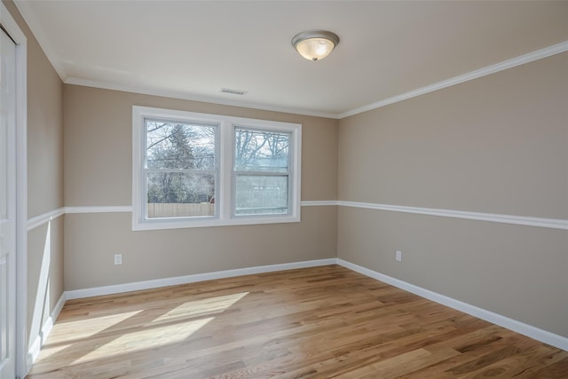 unfurnished room with visible vents, light wood-type flooring, and baseboards