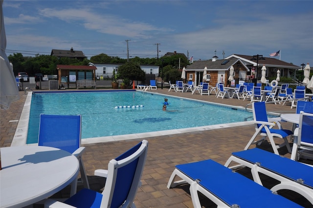 pool featuring a patio and fence