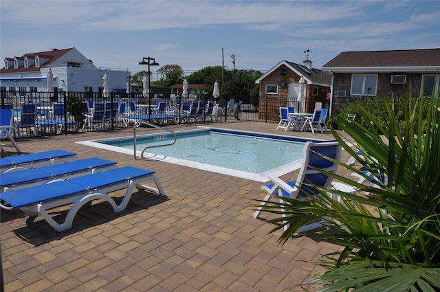 community pool featuring a patio area and fence