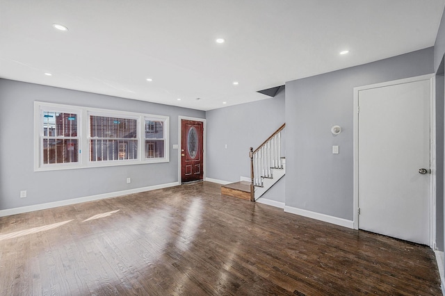 foyer with recessed lighting, stairway, baseboards, and wood finished floors