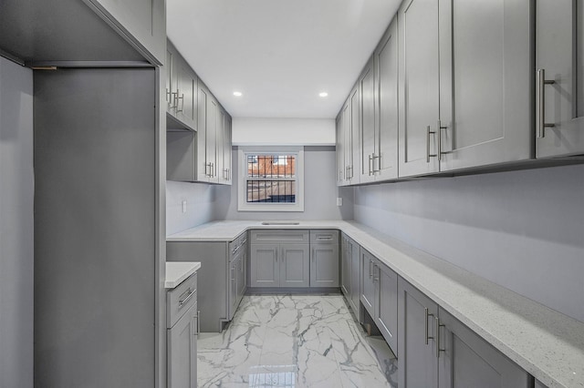 kitchen with recessed lighting, gray cabinets, and marble finish floor