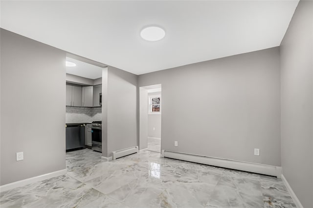 spare room featuring baseboards, marble finish floor, and a baseboard radiator