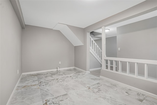 bonus room featuring stairs, baseboards, and marble finish floor