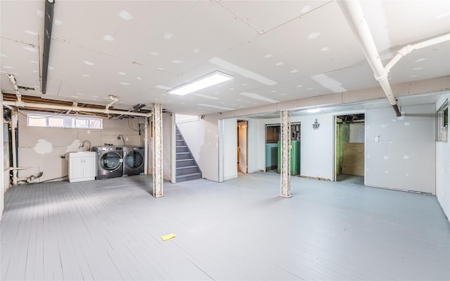 basement with stairway and washer and dryer