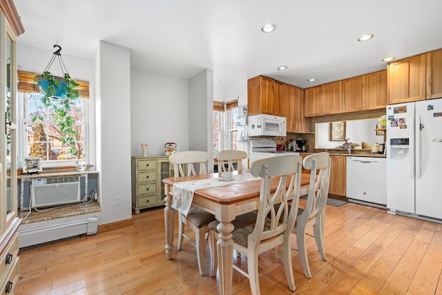 dining space featuring recessed lighting, a healthy amount of sunlight, and light wood-style floors