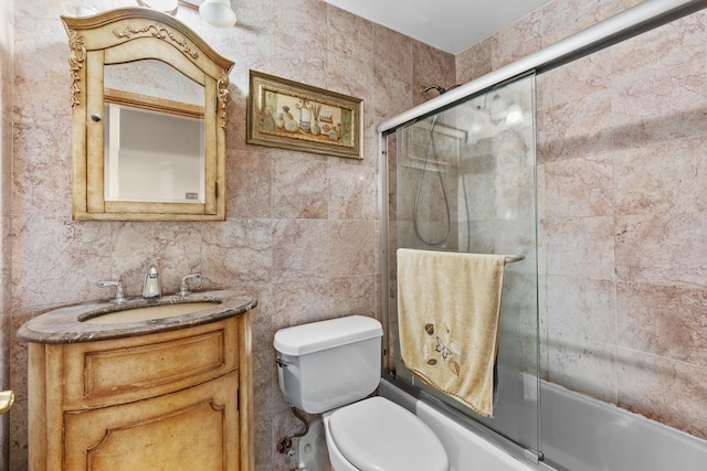 bathroom with vanity, toilet, and enclosed tub / shower combo