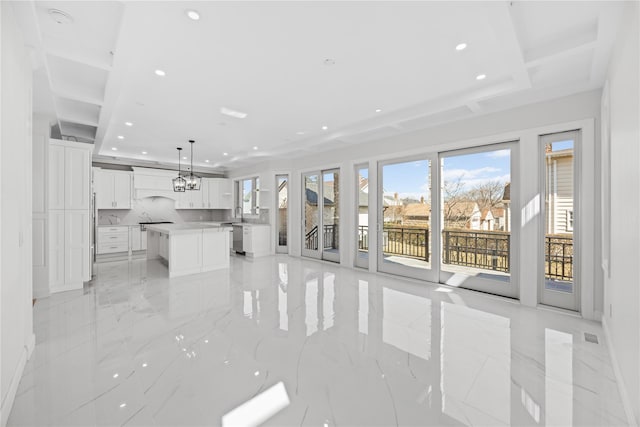 48 Moore St, New Hyde Park, NY 11040 - unfurnished living room featuring recessed lighting, light marble finish floors, and a chandelier