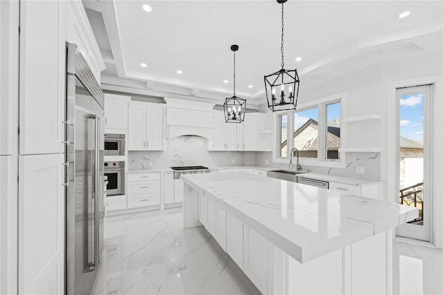 48 Moore St, New Hyde Park, NY 11040 - kitchen featuring stainless steel appliances, a center island, recessed lighting, white cabinetry, and a chandelier
