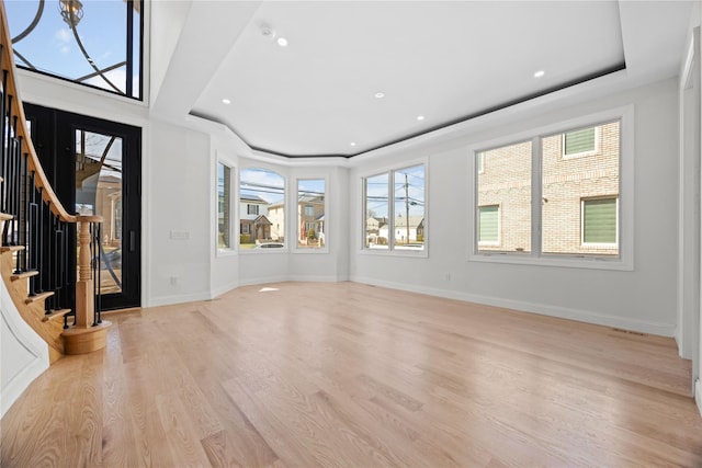 48 Moore St, New Hyde Park, NY 11040 - unfurnished living room featuring stairway, light wood finished floors, recessed lighting, a chandelier, and a raised ceiling