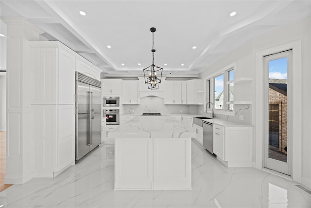 48 Moore St, New Hyde Park, NY 11040 - kitchen with stainless steel appliances, recessed lighting, white cabinets, a kitchen island, and light stone countertops