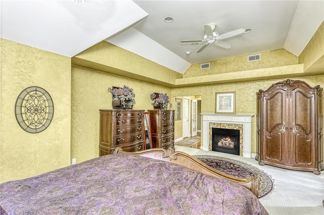 bedroom featuring lofted ceiling, carpet flooring, a fireplace, and visible vents