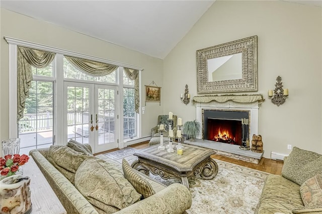 living area with lofted ceiling, wood finished floors, french doors, and a warm lit fireplace