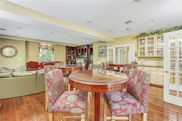 dining room with visible vents, recessed lighting, light wood-type flooring, and beamed ceiling