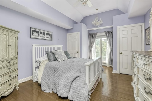 bedroom featuring dark wood finished floors, lofted ceiling, ceiling fan with notable chandelier, and baseboards