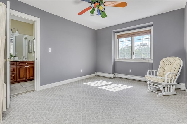 living area featuring baseboards, light carpet, and ceiling fan