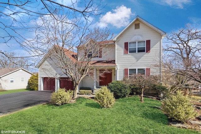 traditional-style house with a front yard and driveway