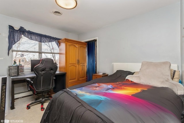 bedroom featuring a baseboard radiator, visible vents, and carpet flooring