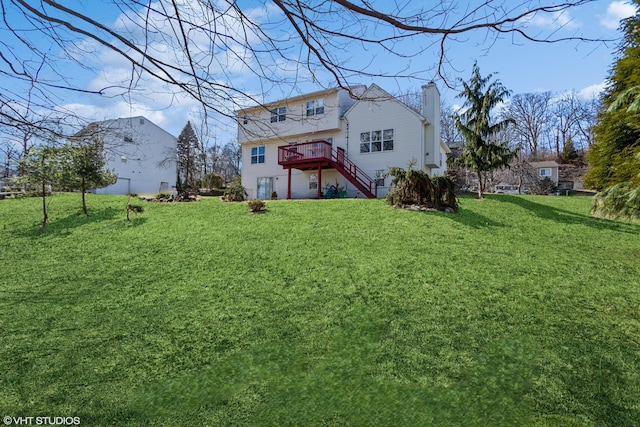 rear view of property with a wooden deck, stairway, a lawn, and a chimney